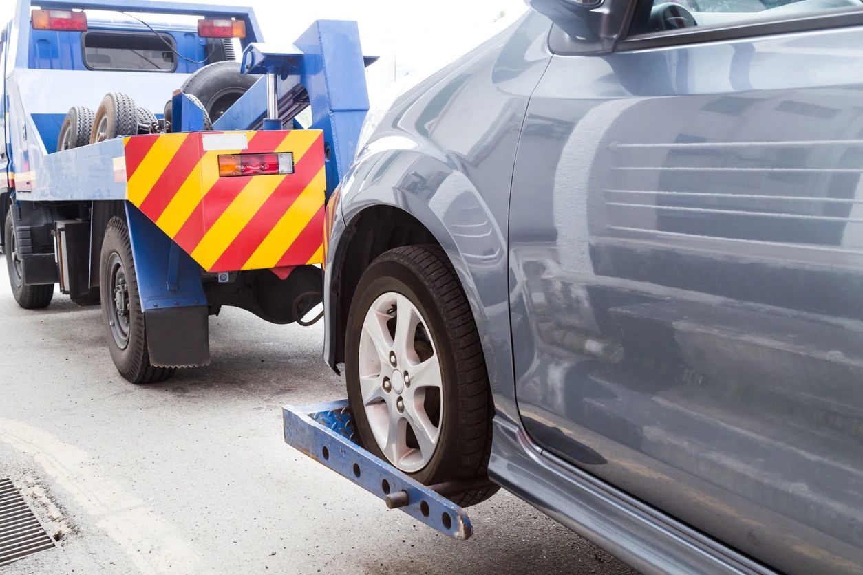 Londonderry Car Accident Lawyer features photo of grey car being towed from accident site 